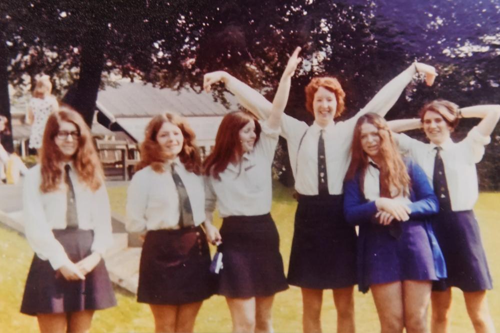 Old school photo - girls on lawn in uniform, sunny day